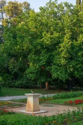 a stone bench in a park with a tree at Central Athenian 1BR Apartment in Athens