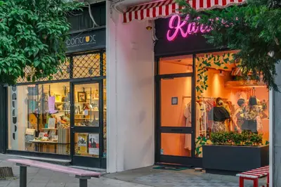 a store front of a store with a pink sign on it at Central Athenian 1BR Apartment in Athens