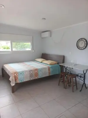 a bedroom with a bed and a table and a desk at studio-02 in Metókhi