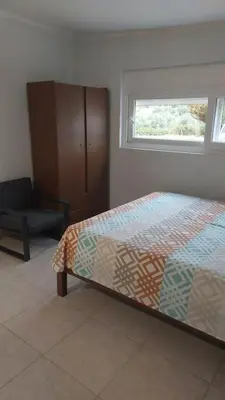 a bedroom with a bed and a chair and a window at studio-02 in Metókhi