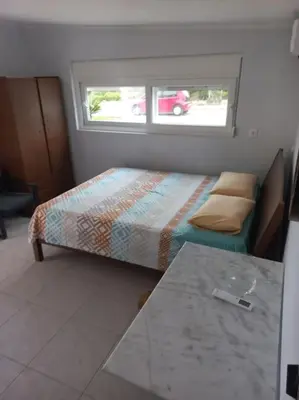 a small bedroom with a bed and a window at studio-02 in Metókhi