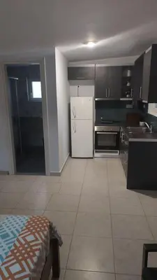 a kitchen with a white refrigerator and a stove at studio-02 in Metókhi