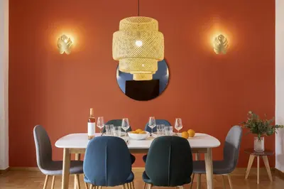 a dining room with a table and chairs and a mirror at A new happy 2 BDR apartment that has a soul in Athens