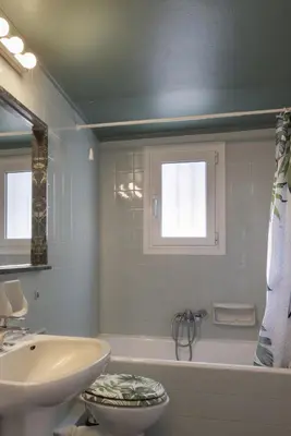 a bathroom with a sink and a tub and a toilet at A new happy 2 BDR apartment that has a soul in Athens