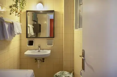 a bathroom with a sink and a mirror at A new happy 2 BDR apartment that has a soul in Athens