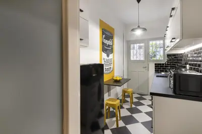a kitchen with a black and white checkered floor at AnapironPolemou5 - Elegance meets charm in a posh in Athens