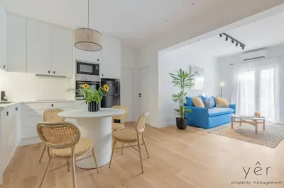 a kitchen and living room with a table and chairs at Luxury Home & Great Location in Athens