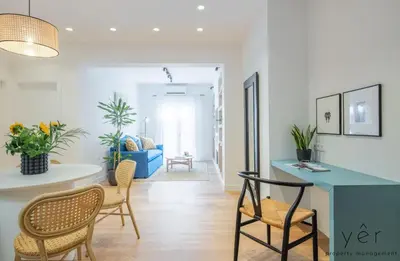 a living room with a blue table and chairs at Luxury Home & Great Location in Athens