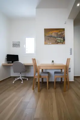 a room with a table and two chairs and a desk at Maxblue 2 in Piraeus