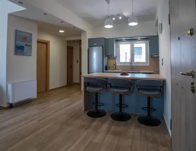 a kitchen with a counter and two bar stools at Maxblue 2 in Piraeus