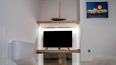 a tv sitting on a table in a room at Maxblue 2 in Piraeus