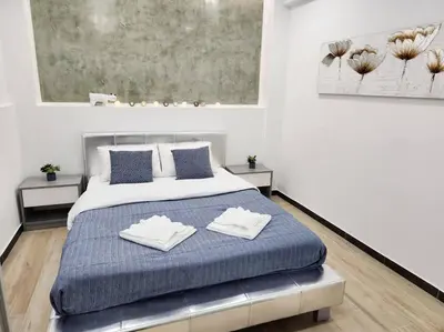 a bedroom with a bed with two towels on it at Kipseli's Home VIPGreece in Athens