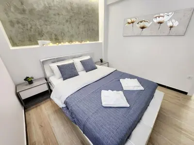 a bedroom with a bed with two towels on it at Kipseli's Home VIPGreece in Athens