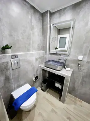 a bathroom with a toilet and a sink and a mirror at Kipseli's Home VIPGreece in Athens