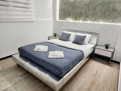a bedroom with a bed with two towels on it at Kipseli's Home VIPGreece in Athens