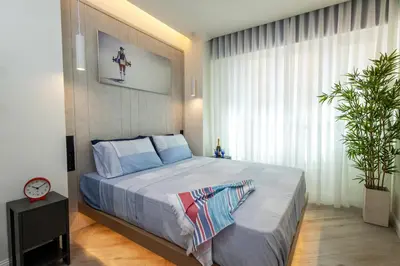 a bedroom with a large bed with a large window at Triple A @ Trendy Psiri - Art & Nightlife in Athens