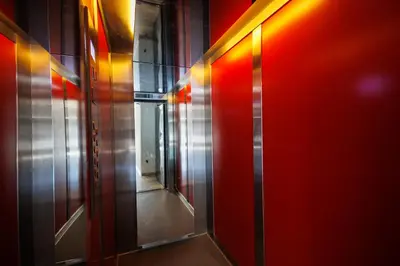 an elevator corridor with red and orange lights at Triple A @ Trendy Psiri - Art & Nightlife in Athens