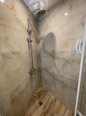 a shower in a bathroom with a marble wall at Pagrati-Brand new luxury central studio in Athens