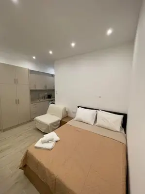 a bedroom with a bed with two towels on it at Pagrati-Luxury central cozy studio in Athens