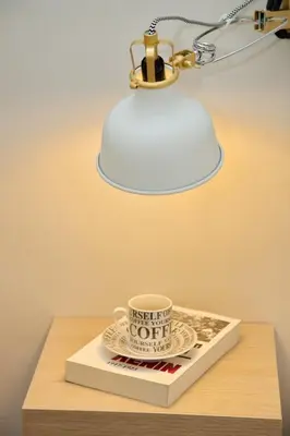 a lamp on a table with a cup and a book at Aroura Homes 2BR Central Balcony Apt Metro in Athens