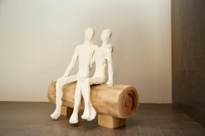 a couple of white figurines sitting on a piece of wood at Aroura Homes 2BR Central Balcony Apt Metro in Athens