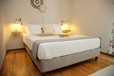 a bedroom with a large white bed with two lamps at Aroura Homes 2BR Central Balcony Apt Metro in Athens