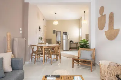 a living room with a table and chairs at Nomad Pennie Home by CloudKeys in Athens