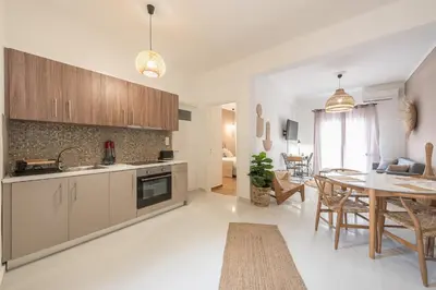 a kitchen and living room with a table and a dining room at Nomad Pennie Home by CloudKeys in Athens