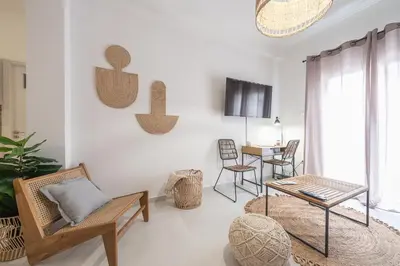 a living room with chairs and a table at Nomad Pennie Home by CloudKeys in Athens