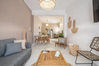 a living room with a couch and a table at Nomad Pennie Home by CloudKeys in Athens