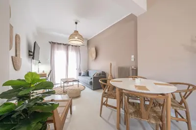 a living room with a table and chairs at Nomad Pennie Home by CloudKeys in Athens
