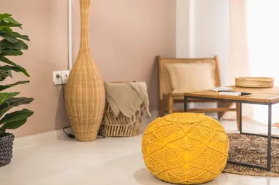 a living room with a table and a yellow ball on the floor at Boho Pennie Home by CloudKeys in Athens
