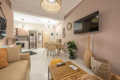 a living room with a couch and a table at Boho Pennie Home by CloudKeys in Athens