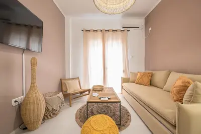 a living room with a couch and a table at Boho Pennie Home by CloudKeys in Athens