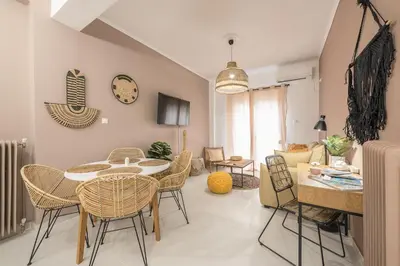 a living room with a table and chairs at Boho Pennie Home by CloudKeys in Athens
