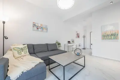 a living room with a couch and a table at Patisia metro Station 100m in Athens