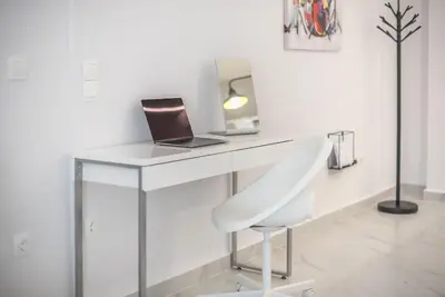 a white desk with a laptop and a chair at Patisia metro Station 100m in Athens