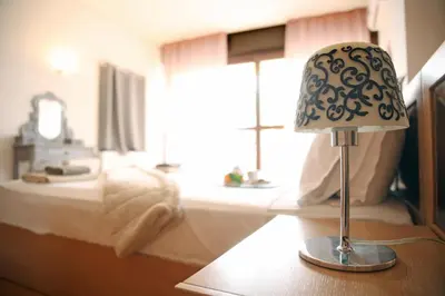 a lamp sitting on a table in a bedroom at Villa 47 in Keratea