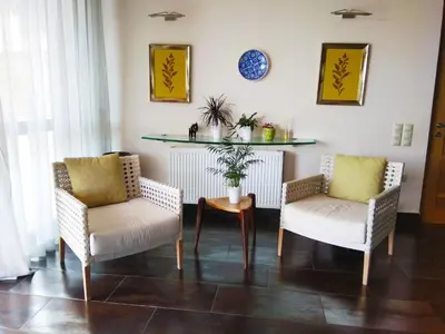 a living room with two chairs and a table at Villa 47 in Keratea
