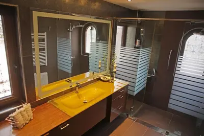 a bathroom with a yellow sink and a mirror at Villa 47 in Keratea