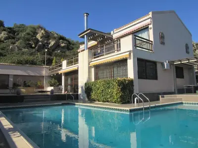 a house with a swimming pool in front of it at Villa 47 in Keratea