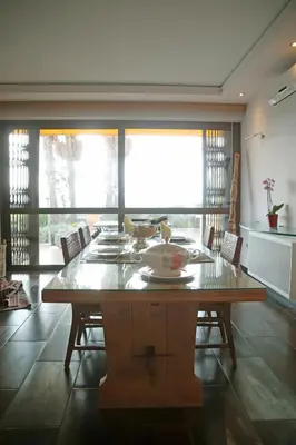 a dining room with a wooden table and chairs at Villa 47 in Keratea
