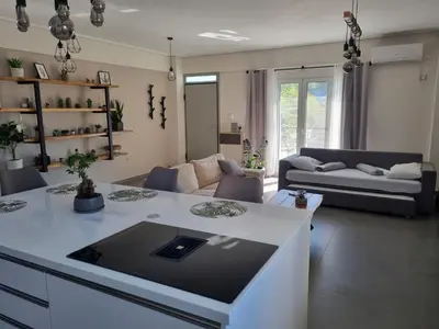a living room with a couch and a table at New minimal apartment,10' from Athens airport in Spáta