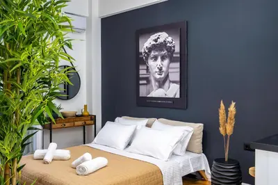 a bedroom with a bed with towels on it at Luxury Studio Apartment in the Heart of Athens in Athens