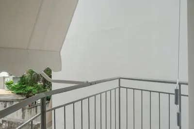 a balcony with a white railing and a white roof at Luxury Studio Apartment in the Heart of Athens in Athens