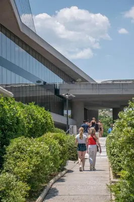 two women walking down a sidewalk in front of a building at Luxury Studio Apartment in the Heart of Athens in Athens