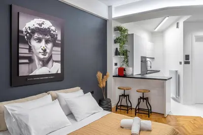 a living room with a bed and a kitchen at Luxury Studio Apartment in the Heart of Athens in Athens