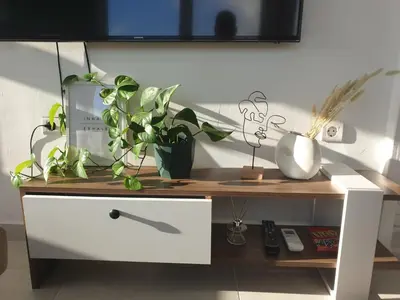 a white cabinet with plants on top of it at Skyline oasis rooftop in Athens