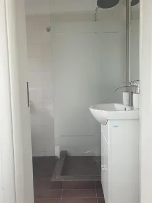 a white bathroom with a sink and a shower at Skyline oasis rooftop in Athens
