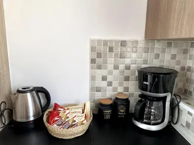 a kitchen counter with a coffee maker and a basket of coffee packets at Skyline oasis rooftop in Athens
